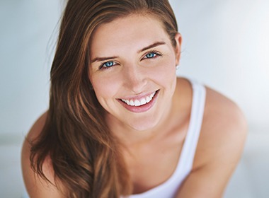 woman in white tank smiling