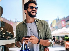 Man smiling while shopping outside