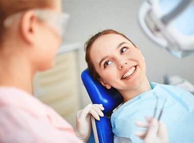 woman laying in blue exam chair