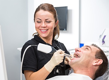 assistant working on man's smile