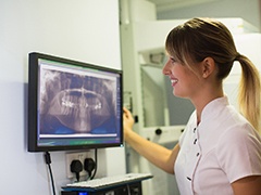 dentist looking at a patient’s X-rays 