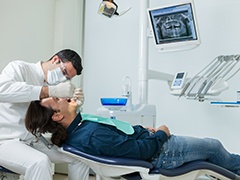 dentist examining a patient’s mouth 