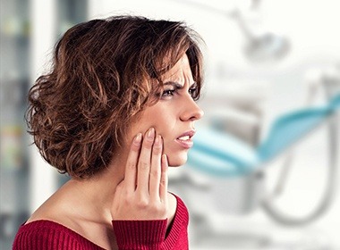 woman in red sweater in pain