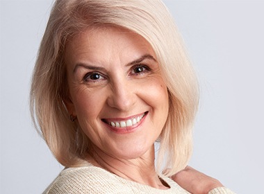 woman in white sweater smiling