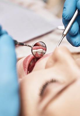 Close up of dentist cleaning a patient’s teeth