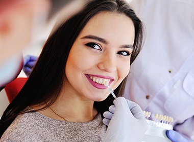 woman comparing veneer shade