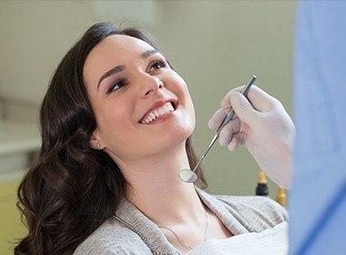 woman smiling up at dentist