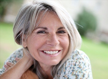 older woman smiling outside