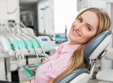 woman in light pink shirt smiling