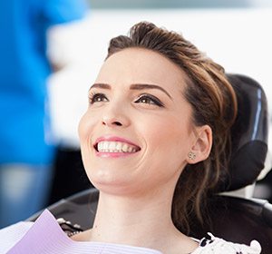 woman laying back in black exam chair