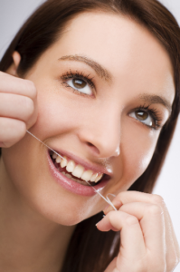 Woman flossing her teeth