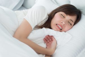 woman grinding her teeth in her sleep