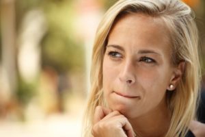 young woman blonde hand on chin