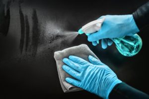 dental assistant disinfecting a surface 