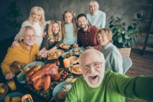 people at table with thanksgiving turkey 