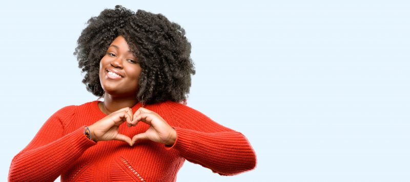 woman smiling making heart sign in Lehigh Valley