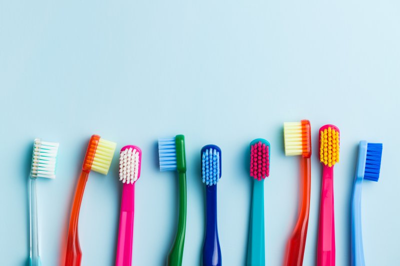 A row of different kinds of toothbrushes