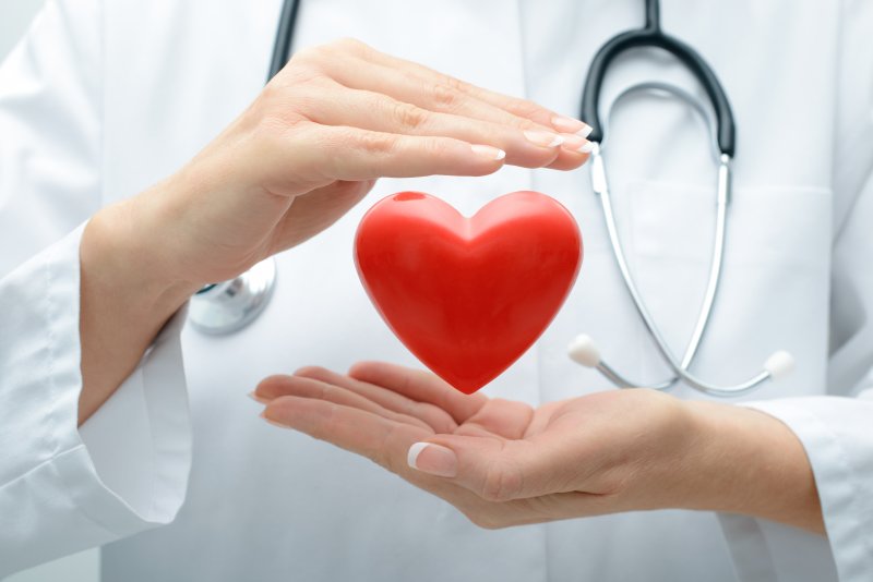 A doctor holding an animated heart