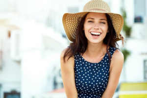 a woman wearing a hat and smiling