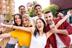 diverse group of friends in the city smiling for the camera