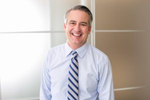 Smiling man wearing dress shirt and tie