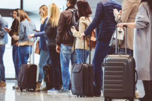 People with luggage standing in line at the airport