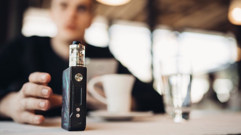 Man vaping despite its affect on oral health