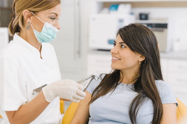 person at dental checkup speaking to dentist